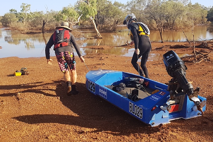 Nat and Steve dragging their boat to the water at Cadjacoothara.
