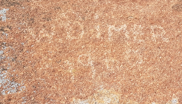 Vandalism or a petroglyph? Dimer was was a well known bush character of the era.