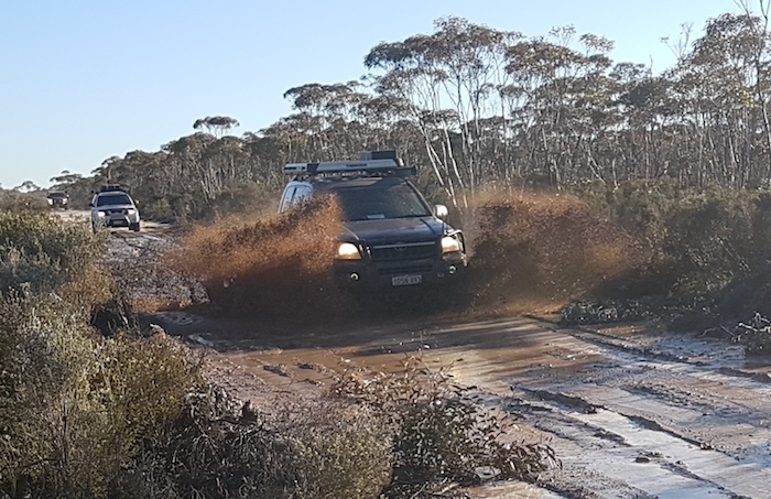 Santokh powers his Prado through the boghole.