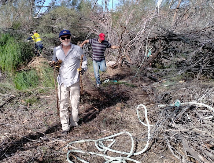 Rob and Andrew clearing away logs and sticks.