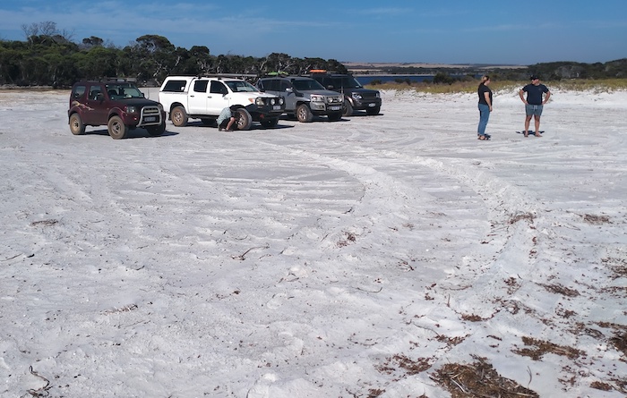 Micaela and Graham with vehicles at the mouth of the Eyre River.
